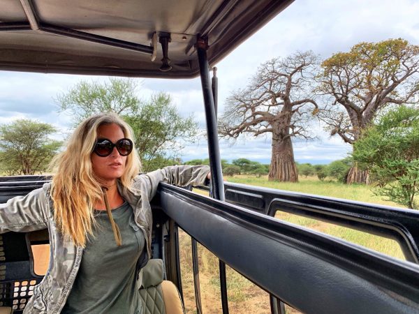 woman-with-blond-hair-sitting-safari-vehicle-national-park